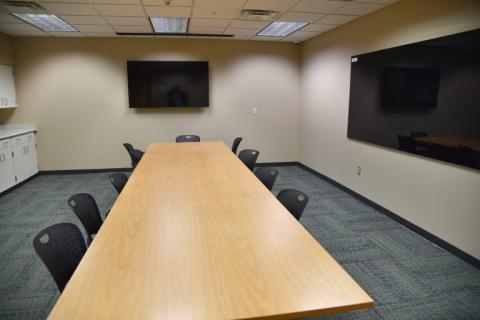 12 people max; Pictured: Fixed boardroom table and chairs